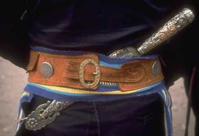 A tirador, a wide leather belt worn by the goucho. The facon, a stylized and docorated swordlike knife, was secured through the back of a rider's belt so it would not kill if he was thrown off his horse.
